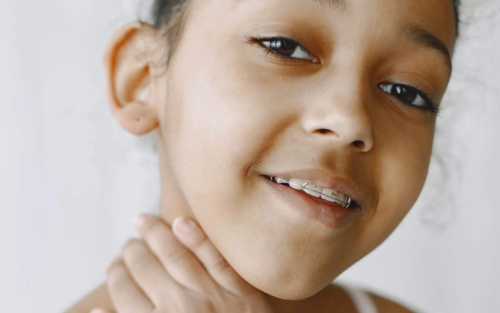 Smiling young girl with metal braces on her teeth